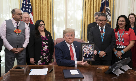 President Trump signs proclamation in the oval office with Native American representatives present