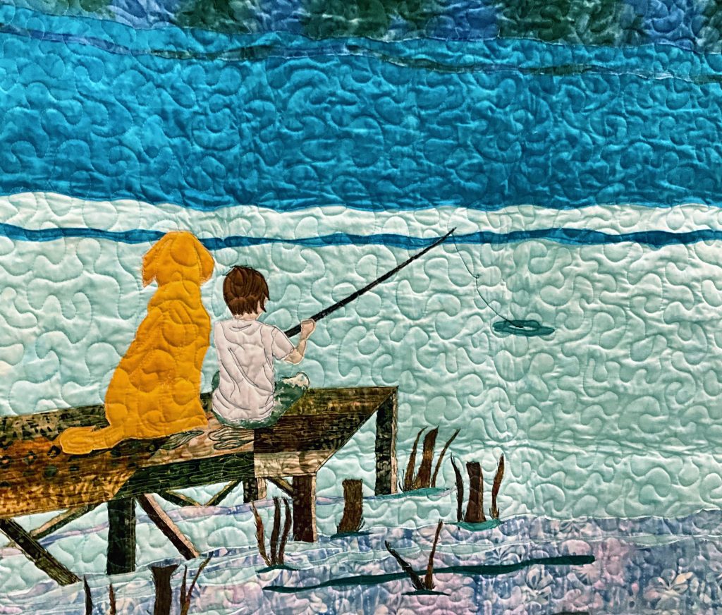 Detail of quilt made by Pamela Foster for Derek VanLuchene. It shows Derek's late dog comforting his late brother, Ryan VanLuchene.